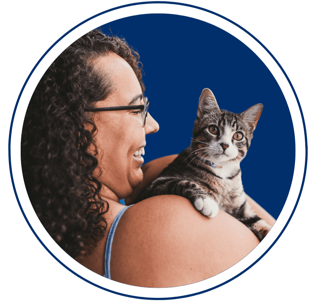 Woman lovingly holding emotional support cat
